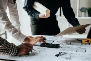 Design management with team reviewing BOM drawings and plans
